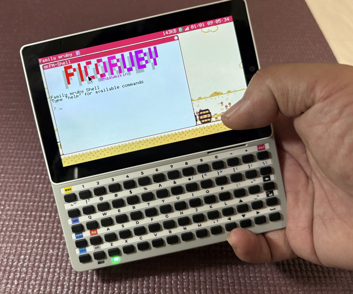 A Tab5 held in one hand, running the Family mruby shell
