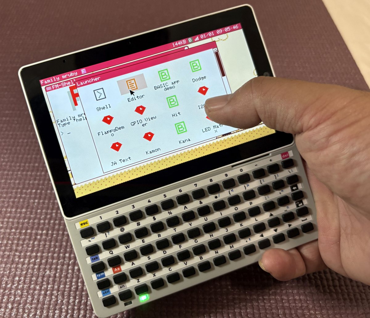 A finger on the Tab5 screen, moving the cursor over the launcher