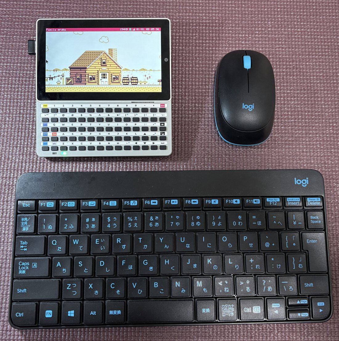 A Tab5 with a wireless keyboard and mouse, their receiver in the USB-A port